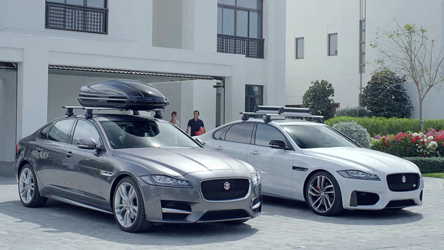 Two Jaguar XF Saloons parked with fitted accessories.